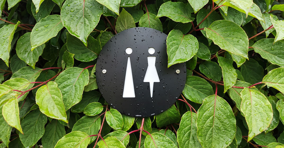 Recycled-ready brushed aluminium unisex toilet sign with stainless steel standoff mounts